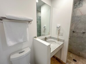 Shower, designer toiletries, hair dryer, towels