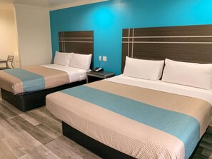 A hotel room with two beds, each with a headboard and a bedside table. - Motel 6 Houston, TX - Hwy 249 and Fallbrook (Houston)