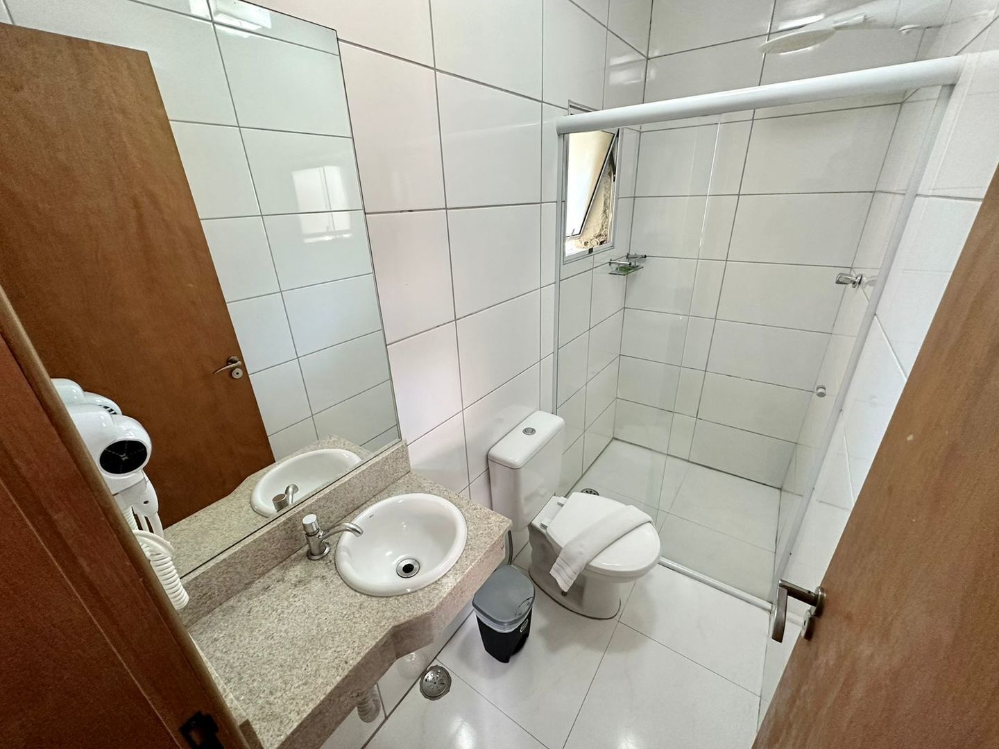 A bathroom with a sink, toilet, and shower.