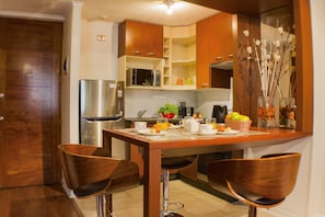 Enjoy cooking in this well-equipped kitchen with a central island, sink, and microwave.