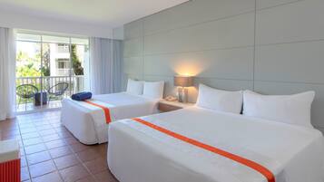 A hotel room with two beds, a balcony with chairs, and a view of the outside.