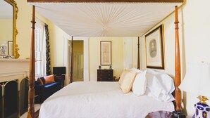 A four-poster bed with a canopy, a dresser, a chair, and a decorative vase. - Brandon Hall Plantation (Natchez)