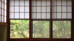 A traditional Japanese room with tatami flooring and shoji screens.