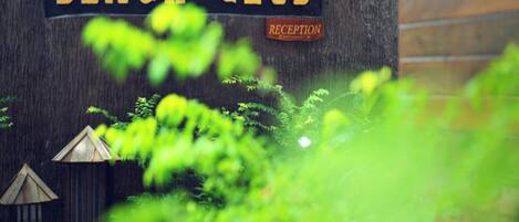 A wooden sign with "BEACH CLUB" and "RECEPTION" written on it.