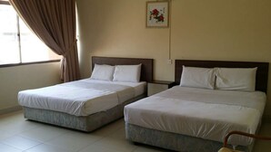 Two single beds with wooden headboards, a window with curtains, and a framed picture on the wall. - Dragon & Phoenix Hotel (Ipoh)