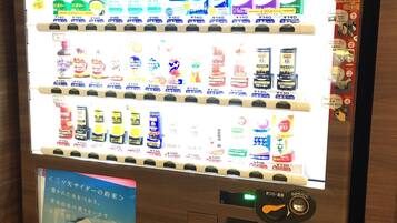 A vending machine with various products, including beverages and snacks, priced in yen.