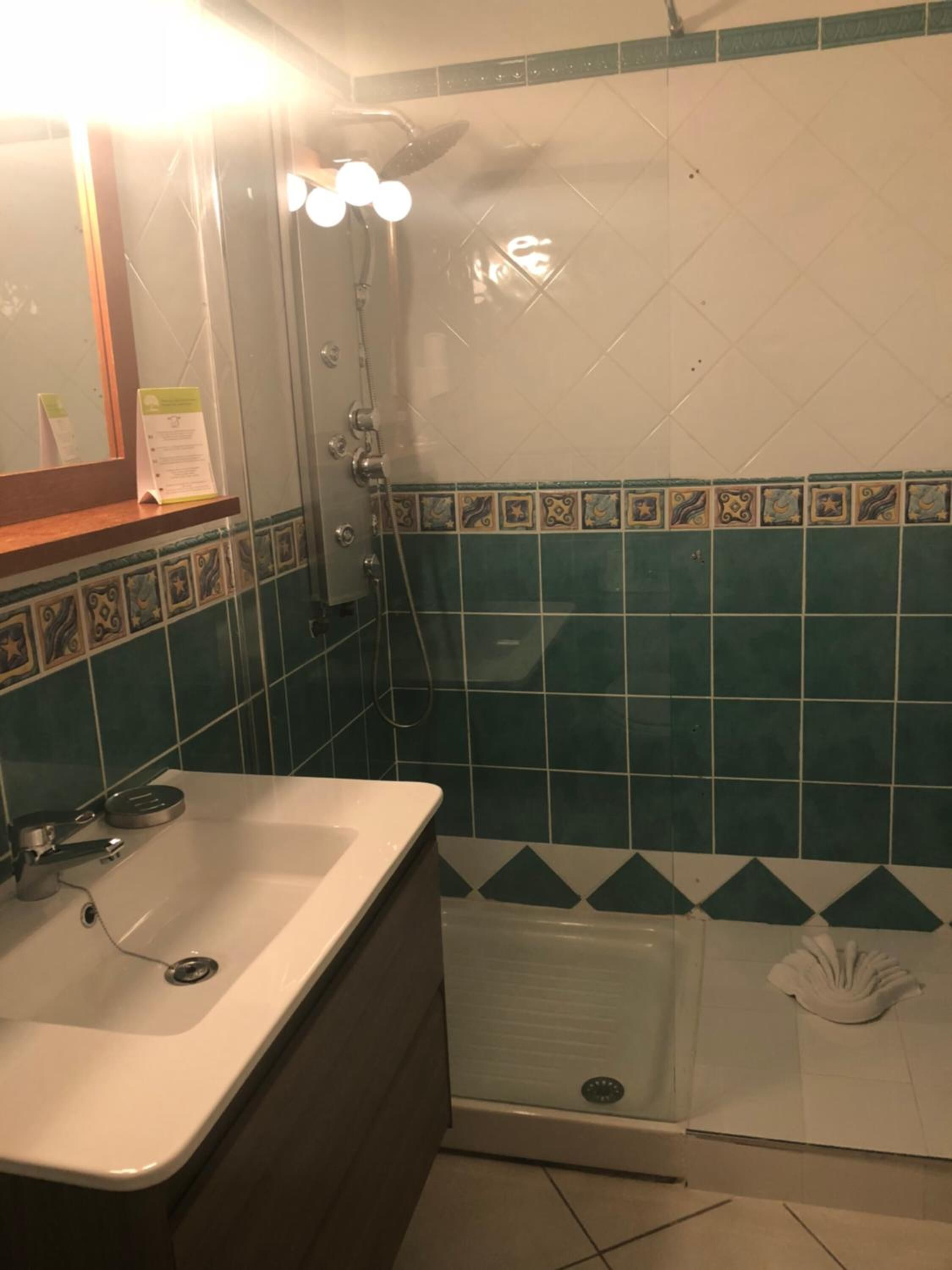 A bathroom with a white sink, a shower, and a bathtub.