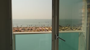 A balcony with a view of a beach.