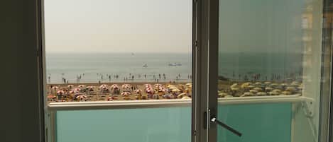 A balcony with a view of a beach.
