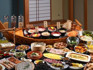A traditional Japanese meal setup with various dishes and a wooden table. - Hotel Gyokusen (Matsue)