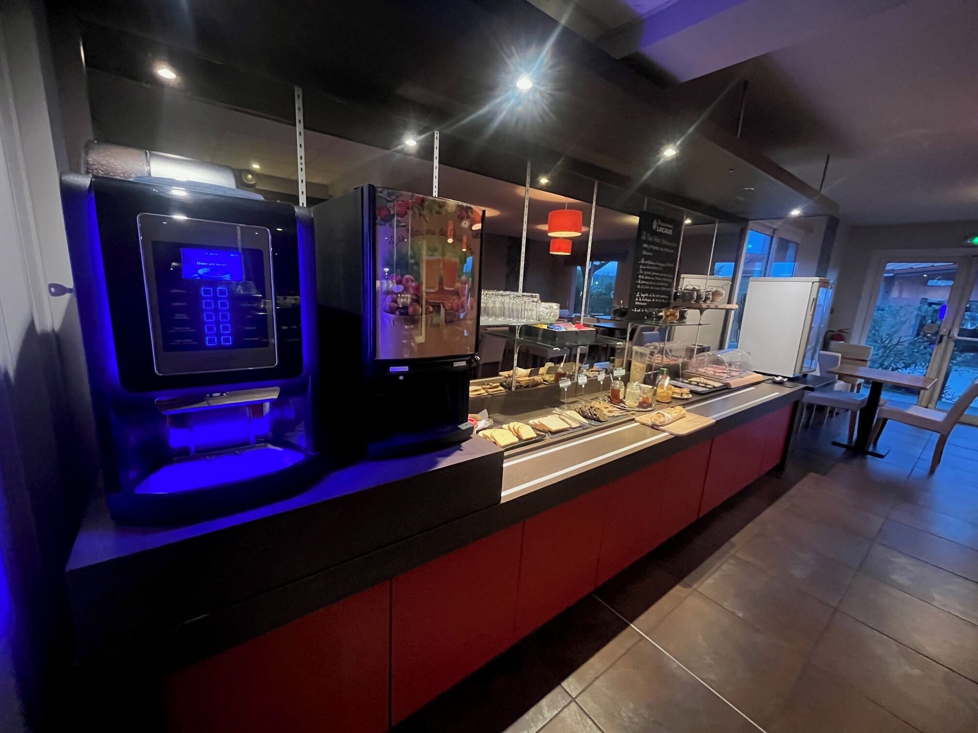 A buffet area with a self-service station and a refrigerated display.