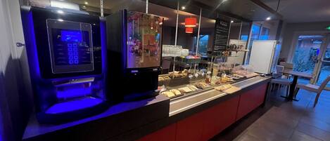 A buffet area with a self-service station and a refrigerated display.