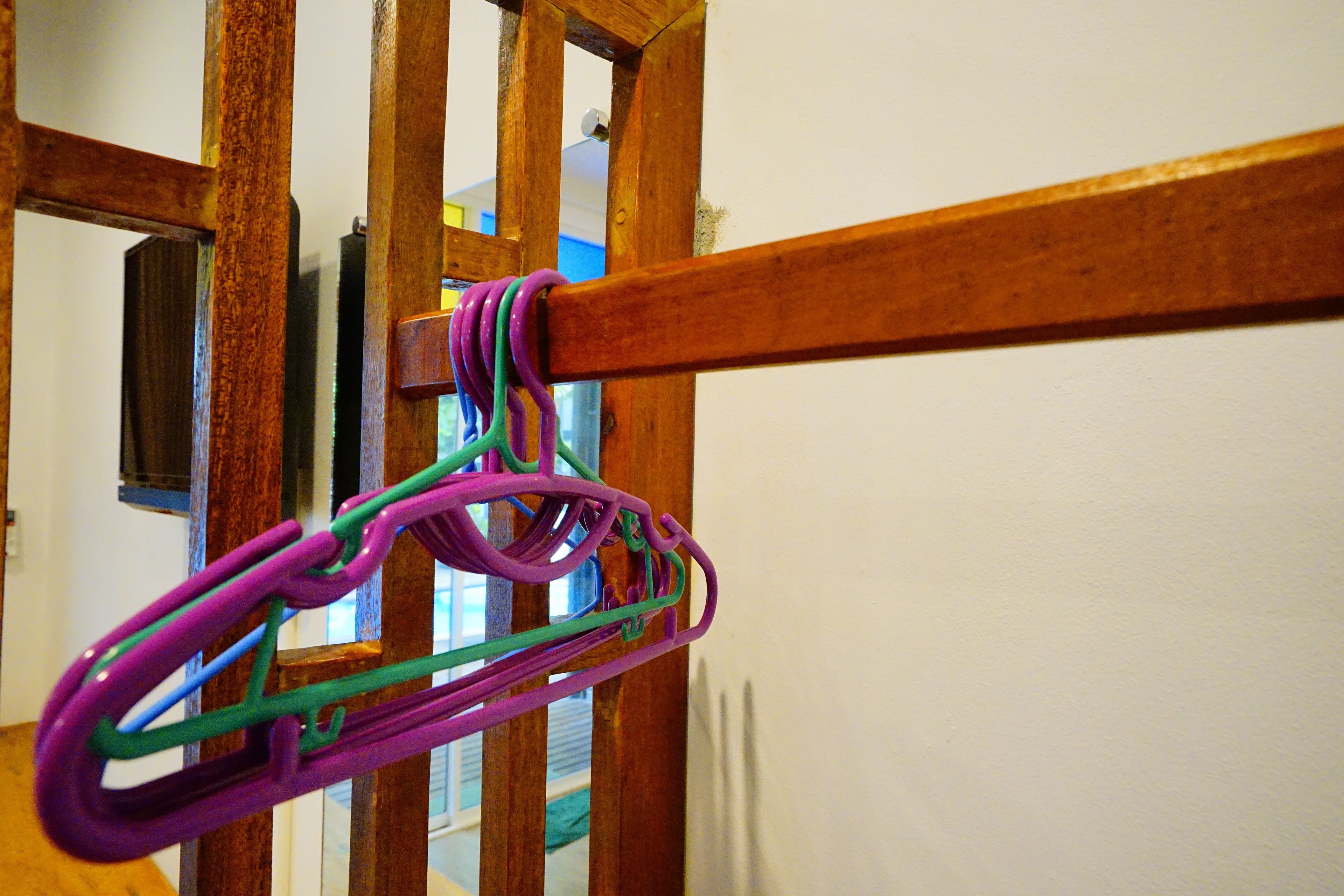 A wooden structure with colorful plastic clips.