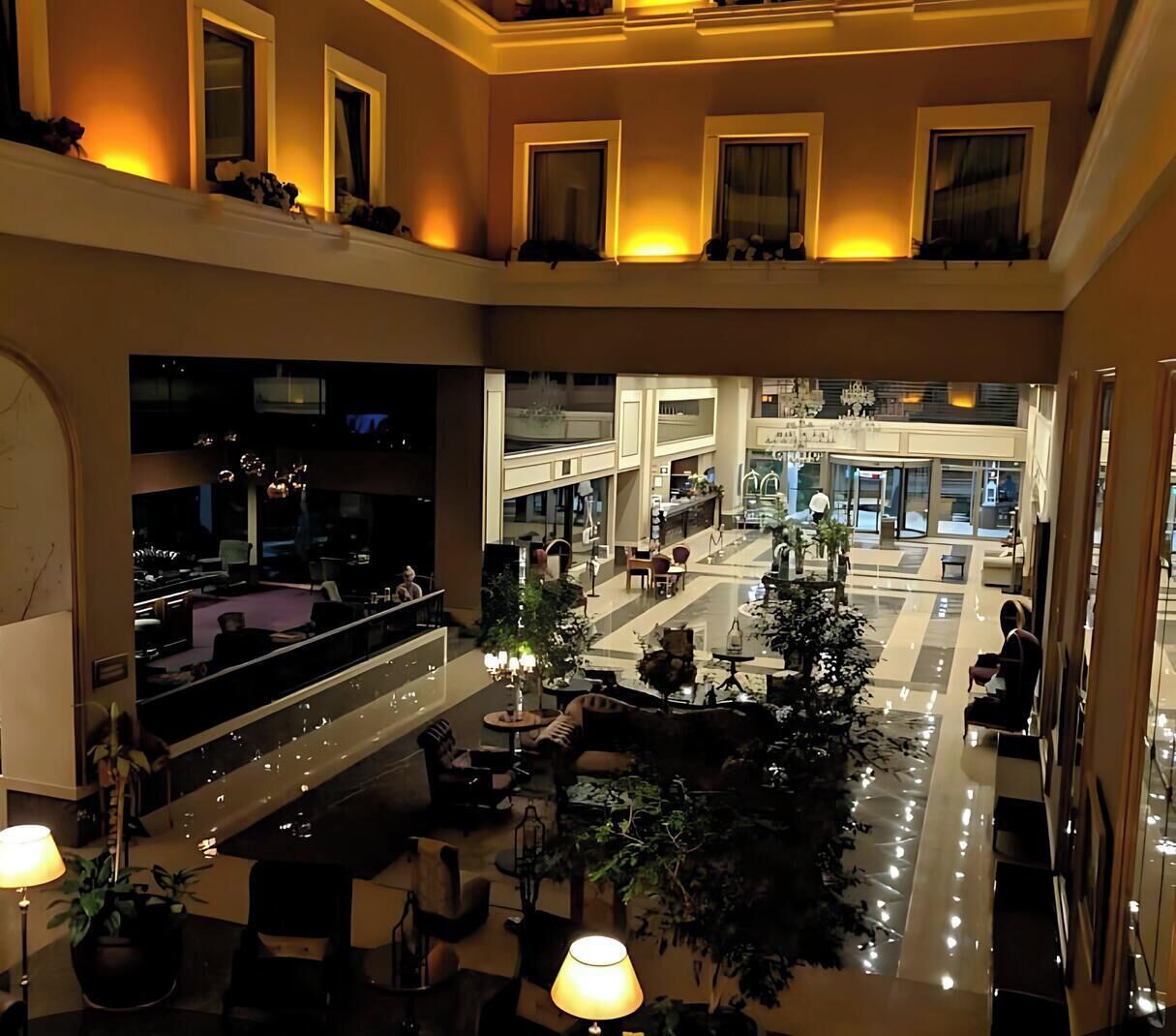 Eine geräumige Lobby mit einer zentralen Sitzecke, mehreren Ebenen und Blick ins Innere.