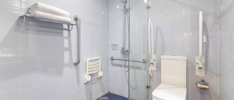 A modern bathroom with a glass shower enclosure, a white toilet, and a towel rack.