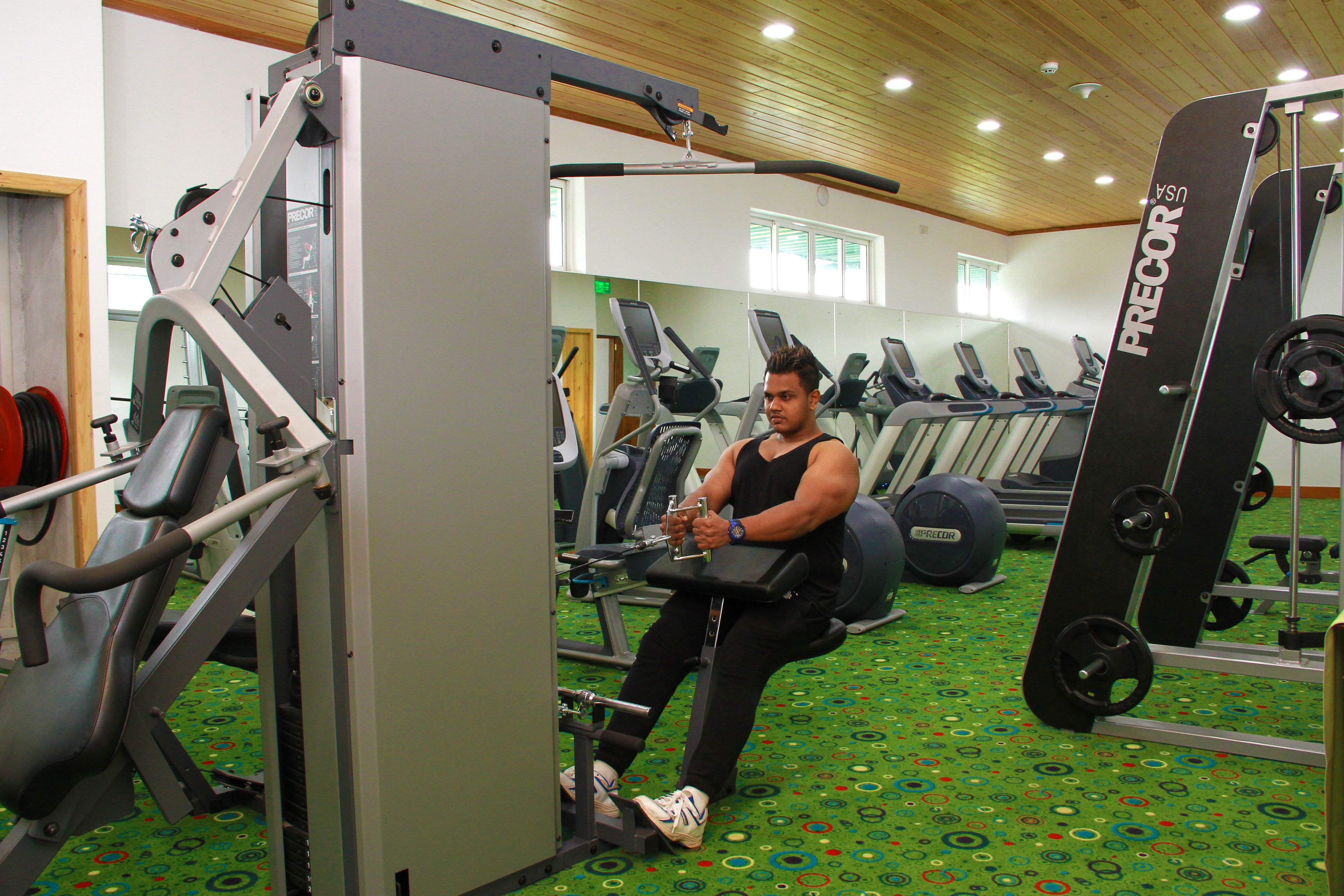 A gym with various exercise equipment, including treadmills and weight machines.