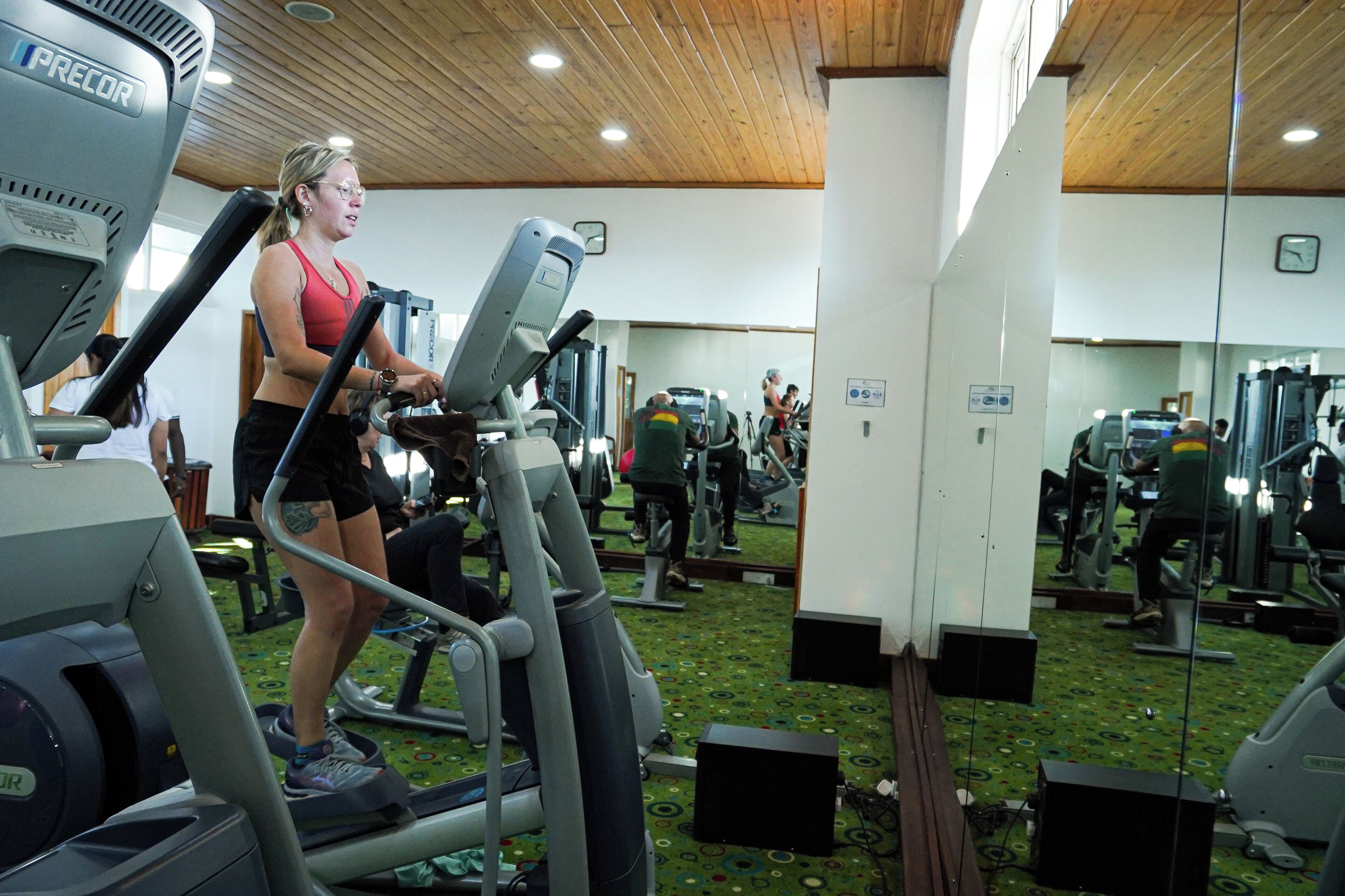 A gym with various exercise equipment, including treadmills and weight machines.