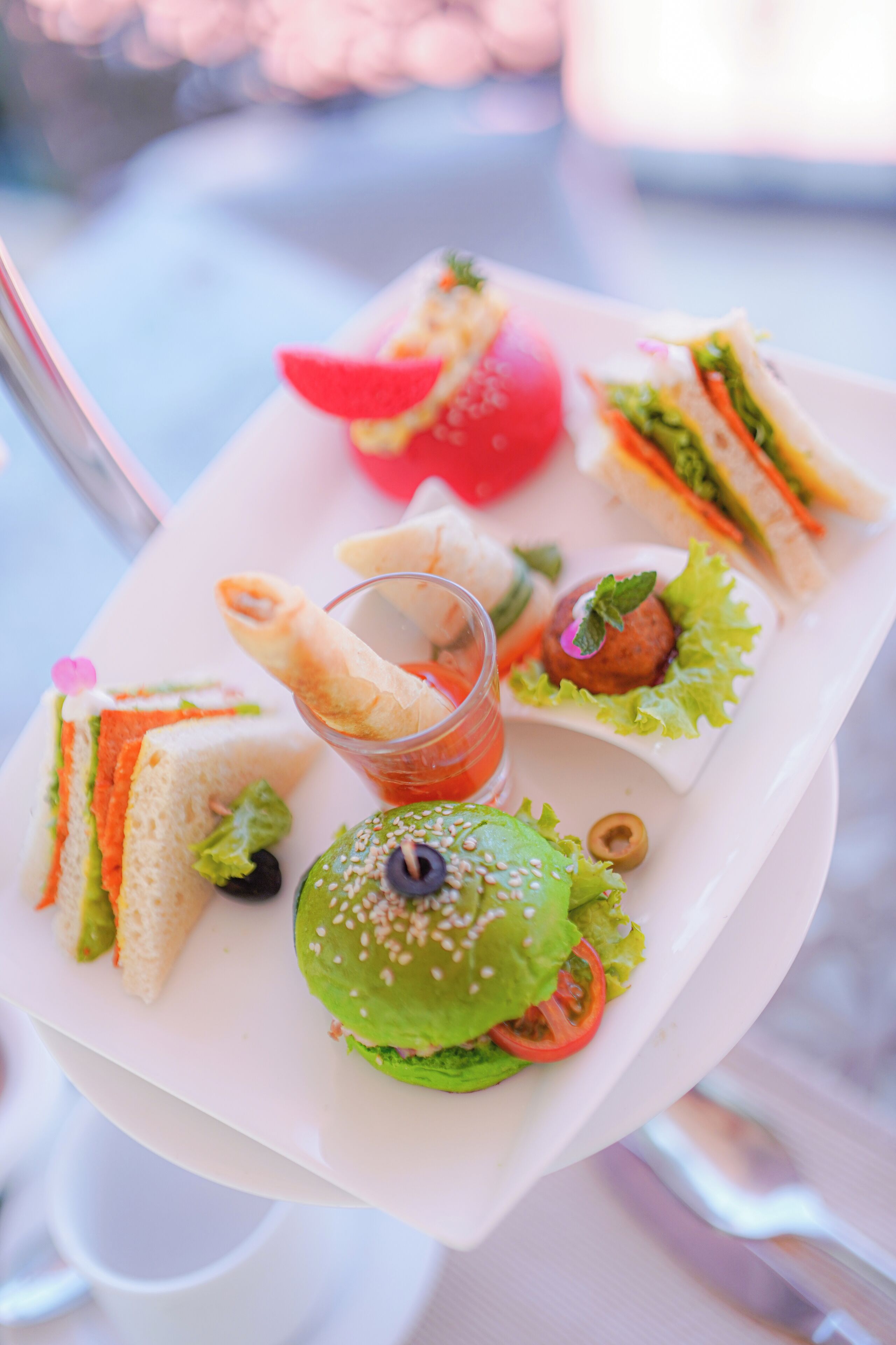 A tray with sandwiches, a burger, and a drink.