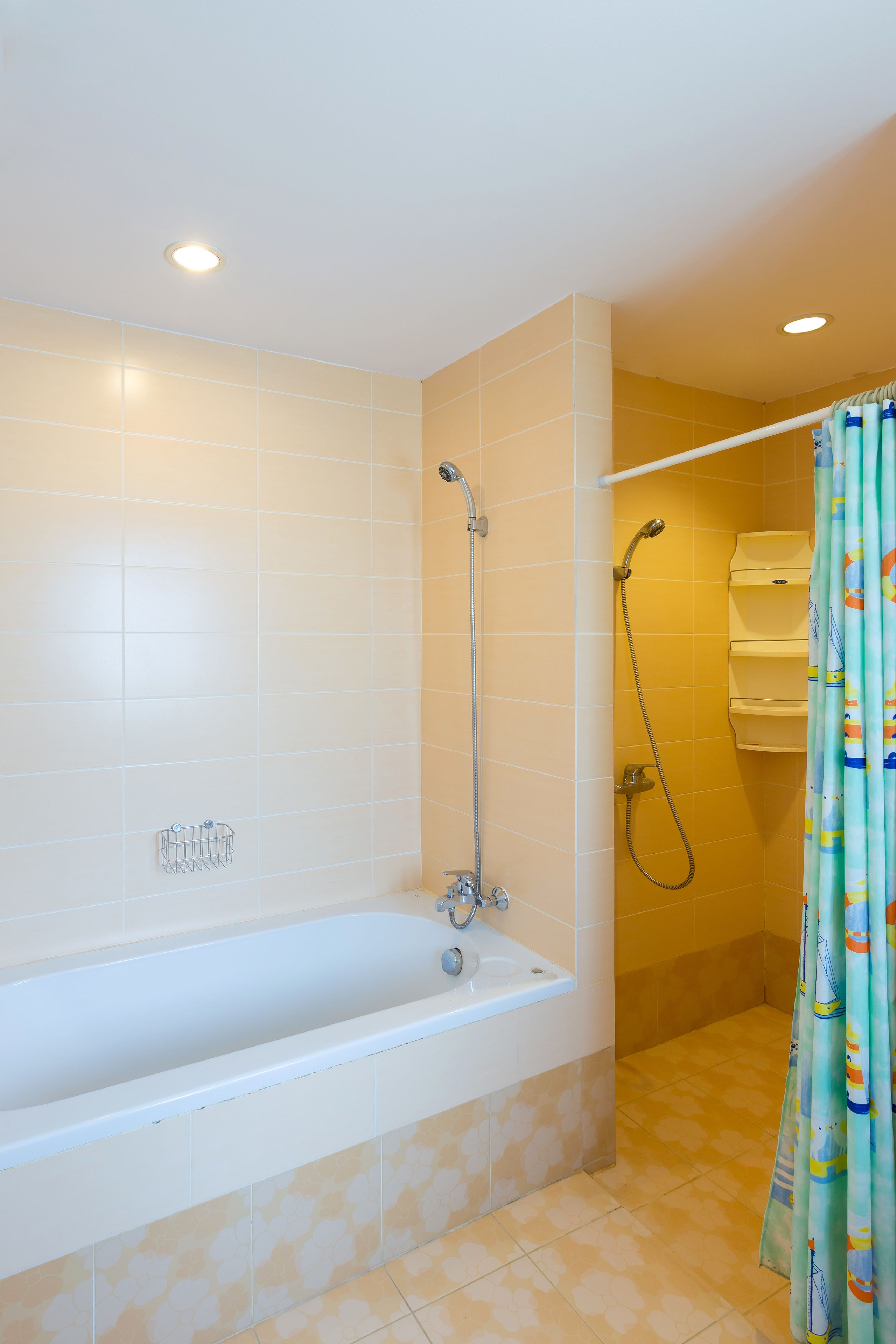 A bathroom with a bathtub, shower, and a towel rack.