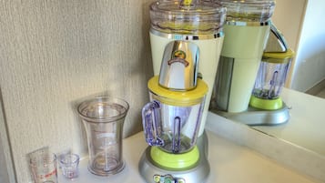 A kitchen with a blender on the counter.