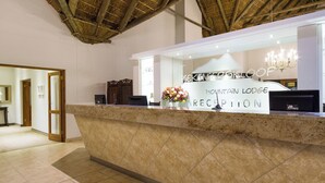 A reception area with a marble counter, a sign reading "Mountain Lodge Reception," and a chandelier. - Piekenierskloof Mountain Resort by Dream Resorts (Bergrivier)