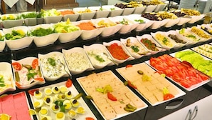 A buffet with various food options including salads, fruits, and prepared dishes. - Grand Pamir Hotel (Istanbul)