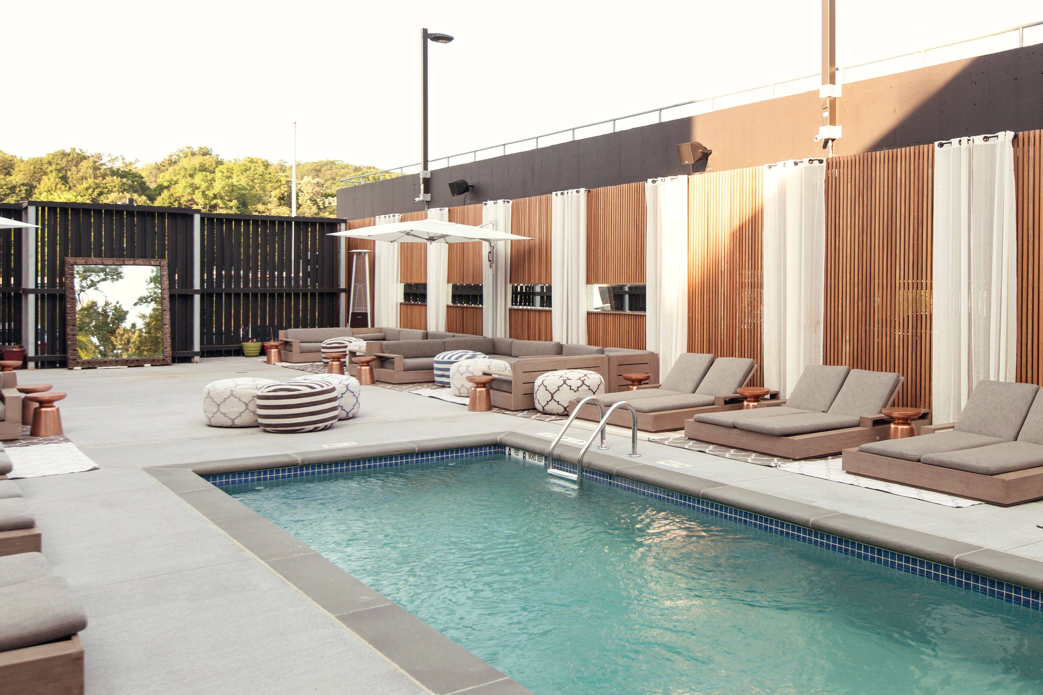 Seasonal outdoor pool, open 9:00 AM to 8:00 PM, pool umbrellas