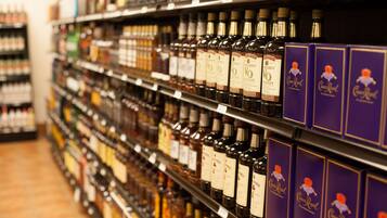 Shelves stocked with various liquor bottles and boxes of Crown Royal.