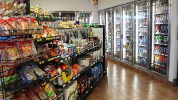 Een gang in een supermarkt met schappen vol verschillende levensmiddelen en dranken.