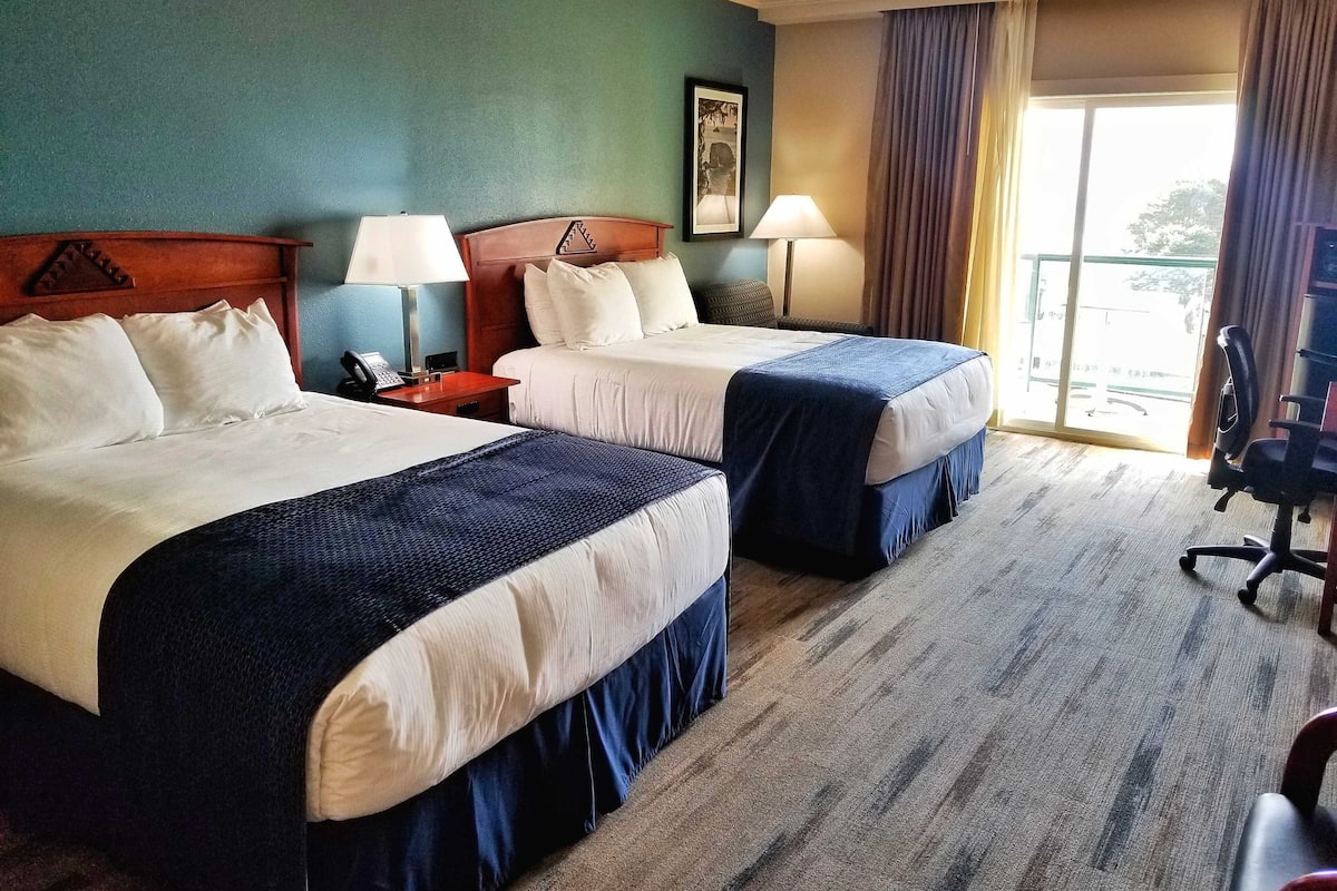 room, 2 queen beds, balcony, partial ocean view | in-room safe, desk, iron/ironing board, rollaway beds