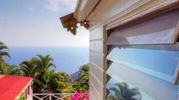 Enjoy a serene poolside retreat surrounded by lush greenery and ocean views.