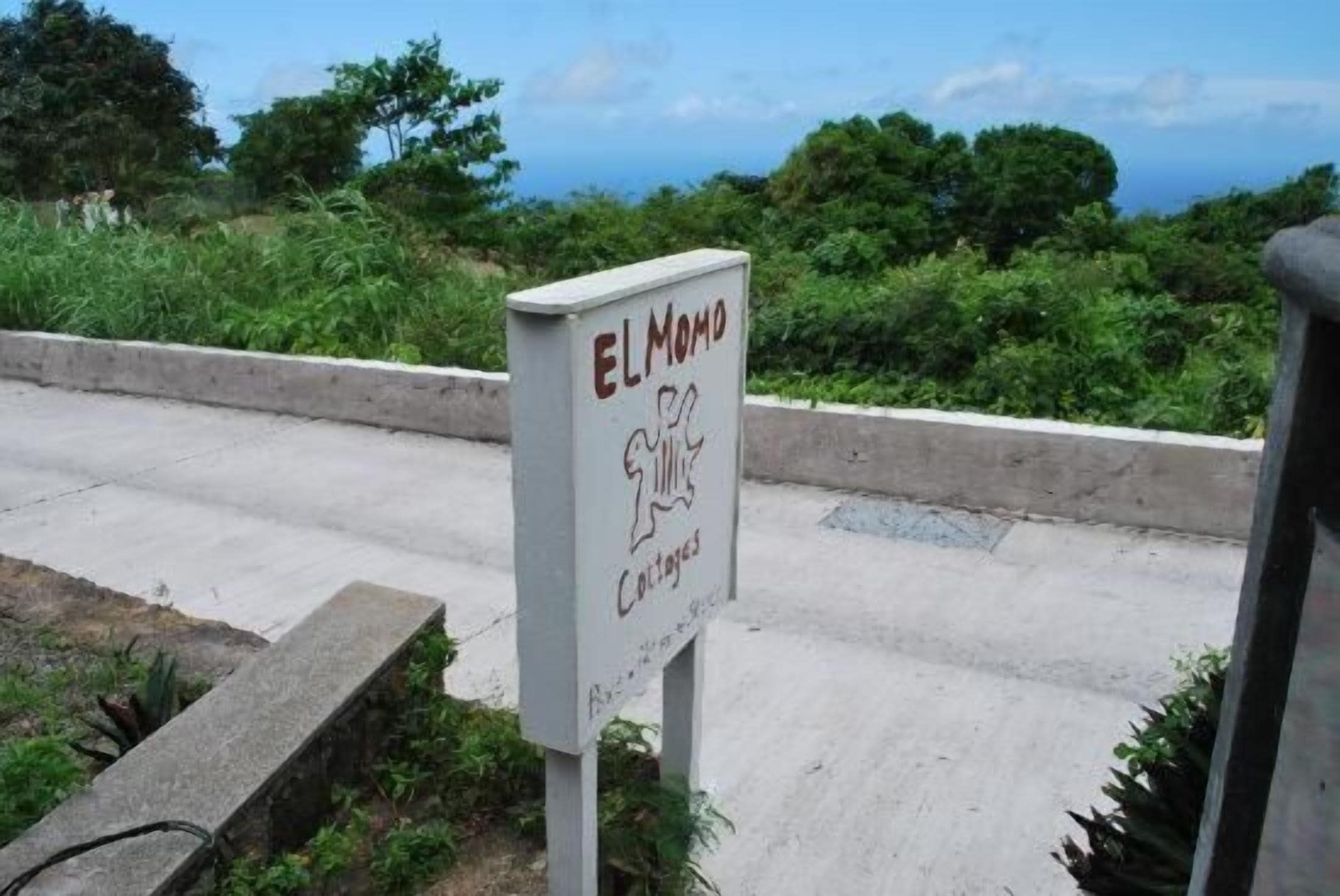 A sign with the text "ELMODO" and "Cottages" indicating a lodging area.