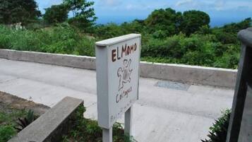 A sign with the text "ELMODO" and "Cottages" indicating a lodging area.