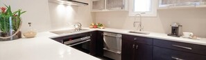 Luxury Suite | Private kitchen | Full-sized fridge, microwave, stovetop, dishwasher