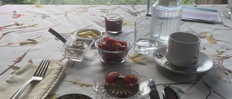 A table set for breakfast with a scenic mountain view.