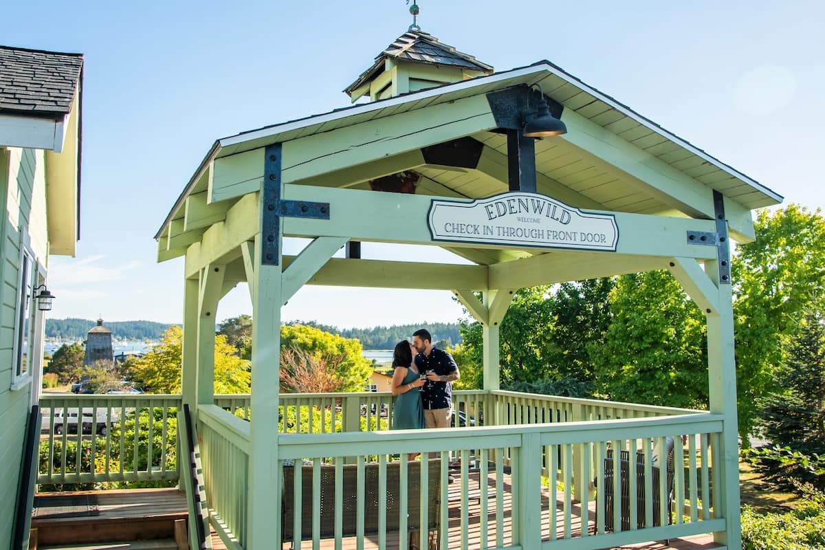 A gazebo with a sign reading "Edenwild Welcome Check In Through Front Door".