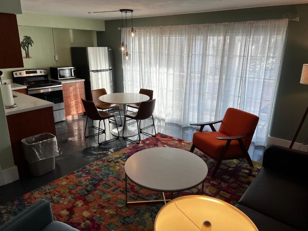 A compact living space with a kitchen, dining area, and seating.