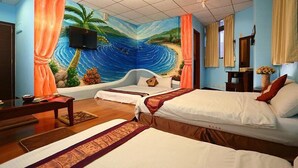 A hotel room with two beds, a TV mounted on the wall, and a mural of a tropical scene. - Love in Hualien (Hualien City)