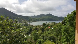 A coastal landscape with a bay, surrounded by hills and dense greenery. - Grand View Guesthouse (Speyside)