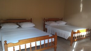 Two wooden beds with white linens in a room with tiled flooring. - Grand View Guesthouse (Speyside)