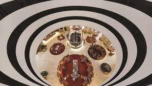A multi-level atrium with circular seating areas and a central open space.