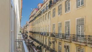 A multi-story building with balconies, a pedestrian street, and outdoor seating. - Behotelisboa (Lisbon)
