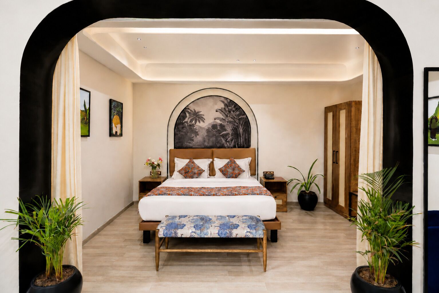 A bedroom with a bed, a headboard with a mural, bedside tables, and potted plants.
