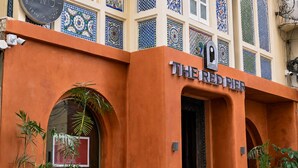 A building with a sign reading 'THE REDPIER' and a circular sign above it. - My Downtown - The Red Pier (Udaipur)