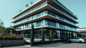 A multi-story building with a modern design, featuring large windows and a flat roof. - Hotel AVA (Neuenkirch)