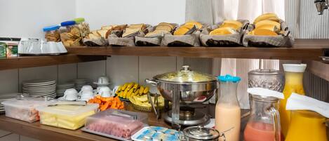 A buffet setup with various food items and beverages.