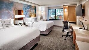 A hotel room with two beds, a desk, a chair, a TV, and a large window with a view. - Courtyard Salt Lake City Downtown (Salt Lake City)