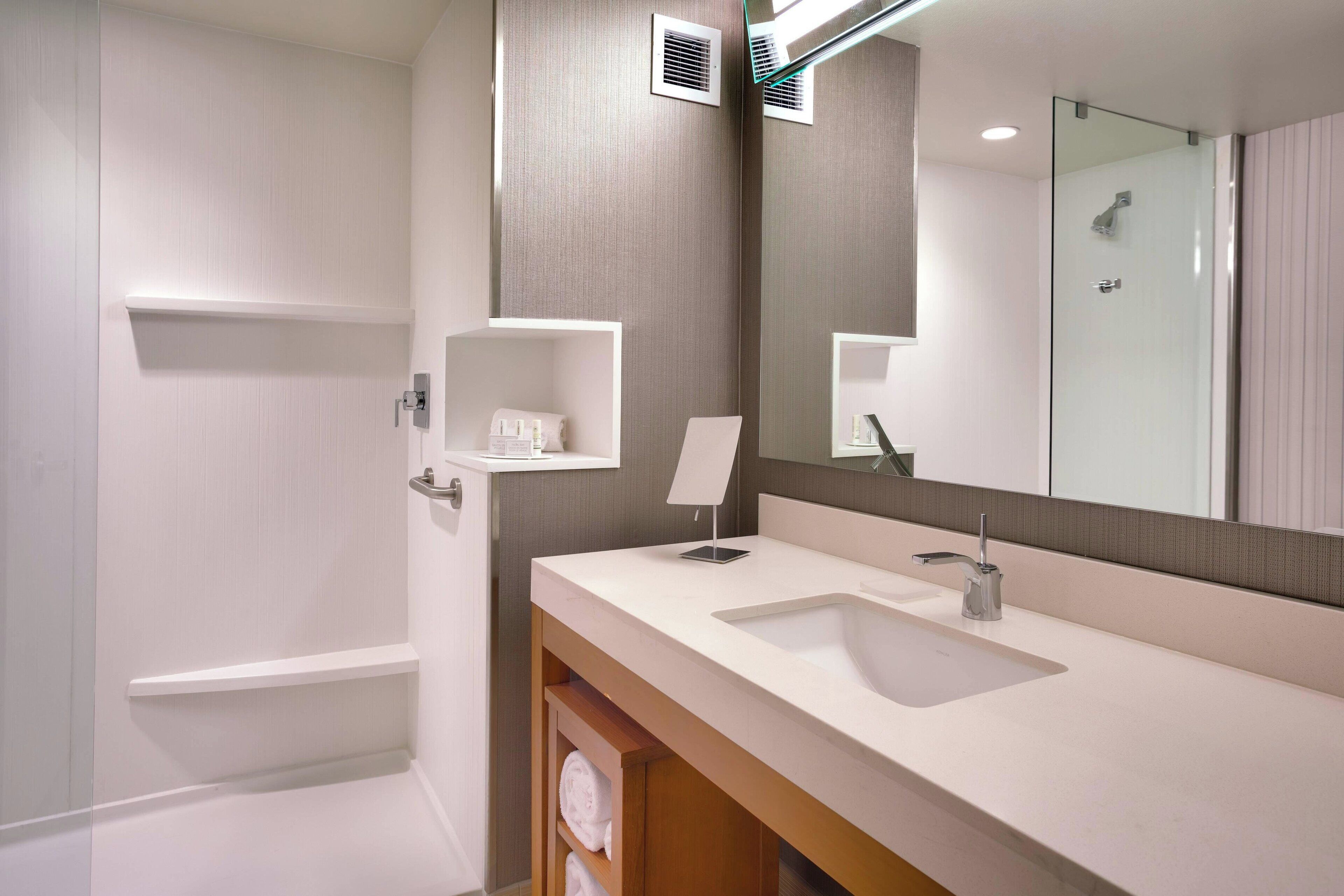 designer toiletries, hair dryer, towels