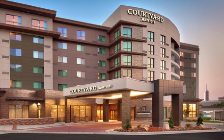 A Courtyard Marriott hotel with a modern design, featuring multiple floors and a prominent entrance with a covered area.