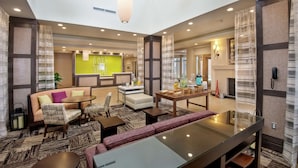 A spacious lobby with a seating area, a reception desk, and a bright green accent wall. - Hilton Garden Inn Pittsburgh Airport South-Robinson Mall (Pittsburgh)